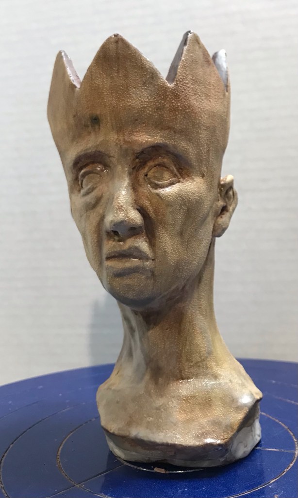 sculpture of a man with a crown